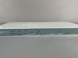 an open book sitting on top of a table next to a white wall