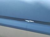a close up of a blue car door handle