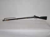a rifle on a table with a white background