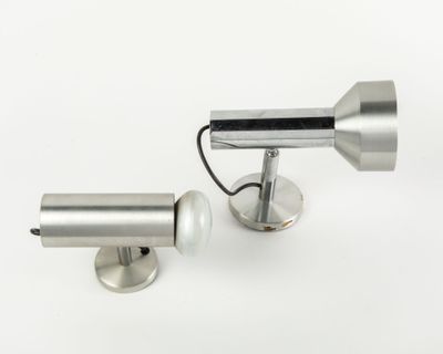 two lamps that are on a white surface