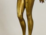 an image of a bronze statue of a man standing on a marble base