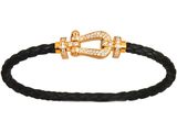 a black leather bracelet with a gold clasp and a diamond clasp