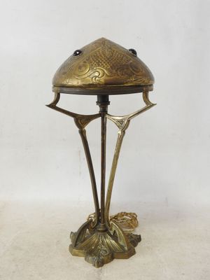 an image of a brass lamp with a bird on it