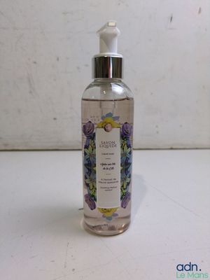 hand sanitizer in a glass bottle on a white surface