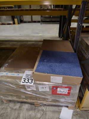 a pallet with a blue carpet on it in a warehouse