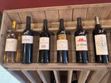 bottles of wine are lined up in a wooden wine rack