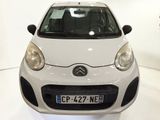 a picture of a small white car in a showroom