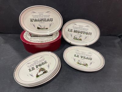 four red and white dishes with labels on them sitting on a black surface