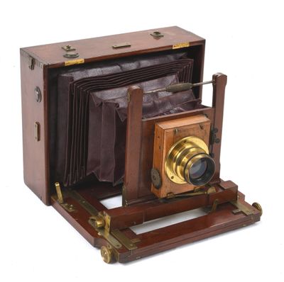 a very old camera with a wooden case on it