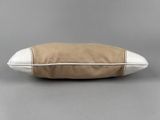 a brown and white pillow sitting on top of a table