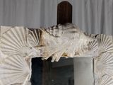 a mirror that has a picture of a shell on it