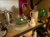 a shelf with dishes and cups on it in the kitchen
