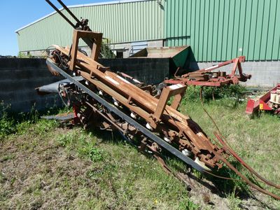 a tractor that is sitting in the grass near a building