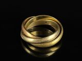 a close up of two gold rings on a black surface