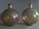 two vases that are sitting on a table