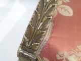 a close up picture of a chair with a gold leaf design on it