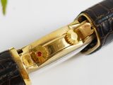a close up of a pen with a red stone in it
