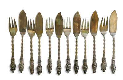 six antique silverware forks and spoons are lined up on a white surface