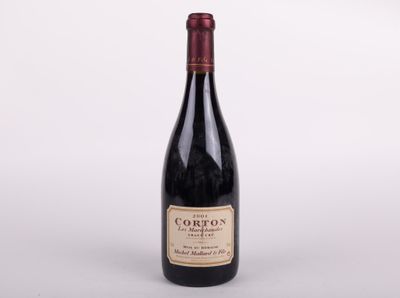 a bottle of red wine sitting on top of a white table