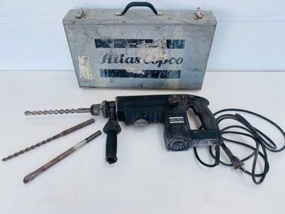 a drill that is sitting next to a tool box