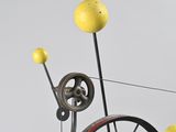 a sculpture of a bicycle with a bunch of balls on it