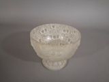 a white glass bowl with a lacy design on it