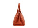 a brown leather handbag on a white background