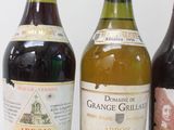 three bottles of wine are lined up on a white surface