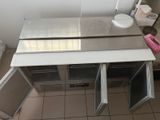 a kitchen with a sink and a refrigerator in it
