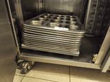 many trays of muffins in the oven on the shelf