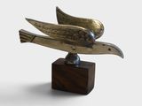 sculpture of a bird on a wooden base on a white background