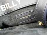 a close up of a black bag with a name tag on it