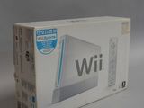Console de jeux Nintendo Wii dans son emballage d'origine, posée sur une surface blanche avec un fond gris