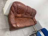 a brown leather chair and a blue chair in a room