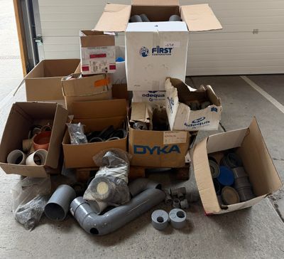 a pile of boxes of assorted items in a garage