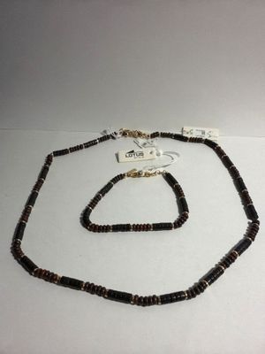a close up of a necklace and bracelet on a white surface