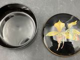 a plate with a picture of a yellow flower on it