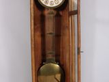 a grandfather clock in a wooden case on a white background
