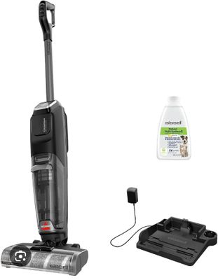 une photo en noir et blanc représentant un aspirateur et un flacon de produit nettoyant