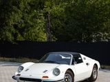 a white sports car that is parked on the side of the road