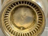a close up of a vase with a clock on it
