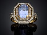a blue sapphire and diamond ring on a black surface