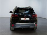 the rear end of a black suv parked in a white room