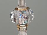 a glass bottle with a crystal decoration on it