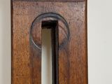 a close up of a wooden clock on a wall