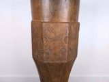 a wooden vase sitting on a wooden floor
