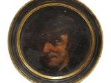 portrait d'un homme coiffé d'un chapeau noir, dans un cadre noir et doré