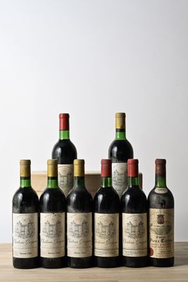 six bottles of wine are lined up on a wooden table