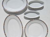 several plates and bowls sitting on a table with a white background