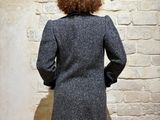 a woman that is standing in front of a brick wall